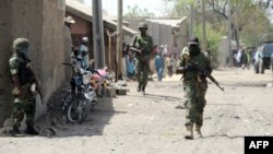 Nigerian soldiers are seen patrolling a town in the north-eastern state of Borno in this April 30, 2013, file photo.