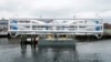 FILE - The Energy Tide 2, the largest tidal energy turbine ever deployed in the U.S., appears on a barge in Portland, Maine, June 13, 2011. 