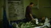 FILE - Dr. Ivan Mozhaiev attends to a patient during morning rounds at Pokrovsk hospital in Pokrovsk, Ukraine, on May 22, 2022. The country's health system is bracing for a second winter of war.