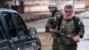 Christian fighters of Sutoro (The Syriac Security Office) carry their weapons as they man a checkpoint in the town of Tel Tamr, Syria, Feb. 25, 2015. 