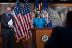 FILE - House Speaker Nancy Pelosi and Senate Minority Leader Chuck Schumer, left, meet with reporters on Capitol Hill in Washington, Nov. 12, 2020.
