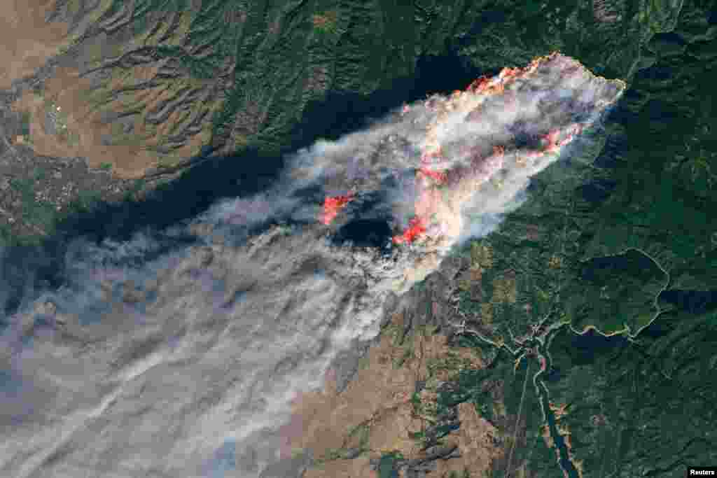 FILE - NASA&#39;s Operational Land Imager satellite image shows the Camp Fire burning at around 10:45 a.m. local time near Paradise, California, U.S., on Nov. 8, 2018.