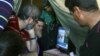 Families of missing soldiers, who were kidnapped by militants from the Islamic State group and al-Qaida's affiliate in Syria, the Nusra Front, watch news on a television about a possible prisoners exchange between Lebanon and the Nusra Front, in tents set for their protest in downtown Beirut, Lebanon, Nov. 29, 2015. 