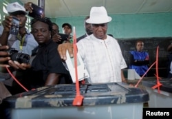 FILE - Joseph Nyuma Boakai, Liberia's vice president and presidential candidate of Unity Party (UP), votes at a polling station in Monrovia, Liberia.