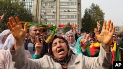 Protesters chant slogans as they protest Saturday's bombing attacks, during a rally in Ankara, Oct. 11, 2015. 