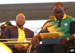 The ruling African National Congress party's new leader, Cyril Ramaphosa, right, and his predecessor, South African President Jacob Zuma, attend the ANC's 106th anniversary celebration in East London, South Africa, Jan. 13, 2018.