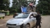 This photo taken on July 2, 2024 shows members of the ethnic armed group Ta'ang National Liberation Army (TNLA) inspecting a car at a checkpoint in the town of Kyaukme in Myanmar's northern Shan State.
