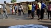 FILE - The body of a man killed is laid on a street in Bujumbura, Burundi after polls opened for the presidential elections, July 21, 2015. 