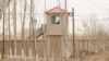 FILE - A security person watches from a guard tower around a detention facility in Yarkent County in northwestern China's Xinjiang Uyghur Autonomous Region, March 21, 2021. China's treatment of Uyghurs has been condemned by human rights organizations as crimes against humanity.