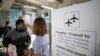 A health worker checks tourists' temperatures as they arrive at Suvarnabhumi Airport, in Bangkok, Thailand, March 4, 2020. 