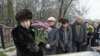 Nataliya Magnitskaya (L), mother of Sergei Magnitsky, grieves over her son's body during his funeral at a cemetery in Moscow November 20, 2009.