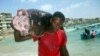 A Somali fisherman carries a fish called "Yapuri" as he walks from Hamarweyne beach in Mogadishu, Somalia, November 22, 2008. 