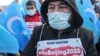 FILE - People from China's Uyghur Muslim ethnic group protest outside the city's Turkish Olympic Committee building, calling for a boycott of the Winter Olympics in Beijing over China's treatment of the minority, in Istanbul, Turkey, Jan. 23, 2022. 