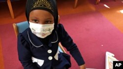 Amira Hassan, of Burnsville, Minnesota, plays in the waiting room at the specialty clinic at Children's Minnesota in Minneapolis, Minnesota, May 2, 2017.