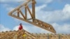 File - Construction workers build a commercial complex in Springfield, Illinois.