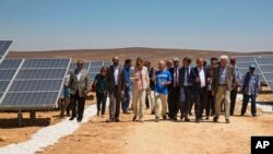 Officials from the IKEA Foundation, and the U.N. refugee agency tour a newly inaugurated solar energy plant, that will provide about 20,000 Syrian refugees with electricity, in the Azraq Refugee Camp, Jordan, Wednesday, April 17, 2017. The foundation funded the plant which makes Azraq, run by the UN, the world’s first refugee camp to be powered by renewable energy and saves $1.5 million a year in electricity costs. 