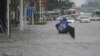 A resident stands on a flooded road in Zhengzhou, Henan province, China July 20, 2021.
