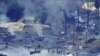 FILE- An illegal oil refinery is pictured in Ogoniland, outside Port Harcourt in Nigeria's Delta region, in March 2011.