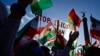 FILE - Protesters hold up a placard reading "Stop Execution in Iran" as they take part in a rally in support of the demonstrations in Iran, in front of the Victory Column in Berlin, Oct. 22, 2022.