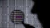 FILE - A photo illustration shows a man in front of a Yahoo logo seen through a magnifying glass in front of a displayed cyber code.