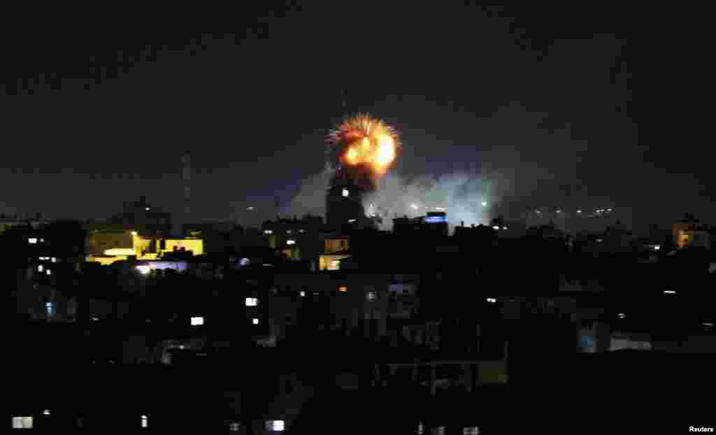 Smoke and flames are seen following what witnesses said was an Israeli air strike in Rafah, in the southern Gaza Strip, July 11, 2014. 