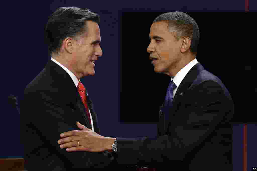 Republican presidential nominee Mitt Romney and President Barack Obama shake hands after the first presidential debate at the University of Denver.