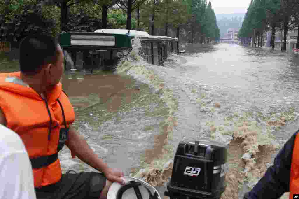A boat goes pass a flooded street in Anju City, South Phyongan Province, in North Korea, July 30, 2012.