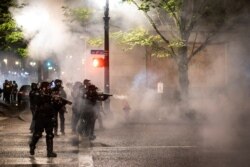 Federal law enforcement officers stand guard during unrest that followed the grand jury decision in Louisville's Breonna Taylor case, in Portland, Oregon, Sept. 23, 2020.