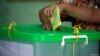 FILE - A voter cast her ballot for the by-election in Yangon, Myanmar, Nov. 3, 2018. 