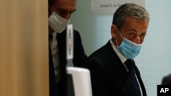 Former French President Nicolas Sarkozy leaves the courtroom in Paris, March 1, 2021. A Paris court found him guilty of corruption and influence peddling and sentenced him to one year in prison, Sep 30, 2021. 