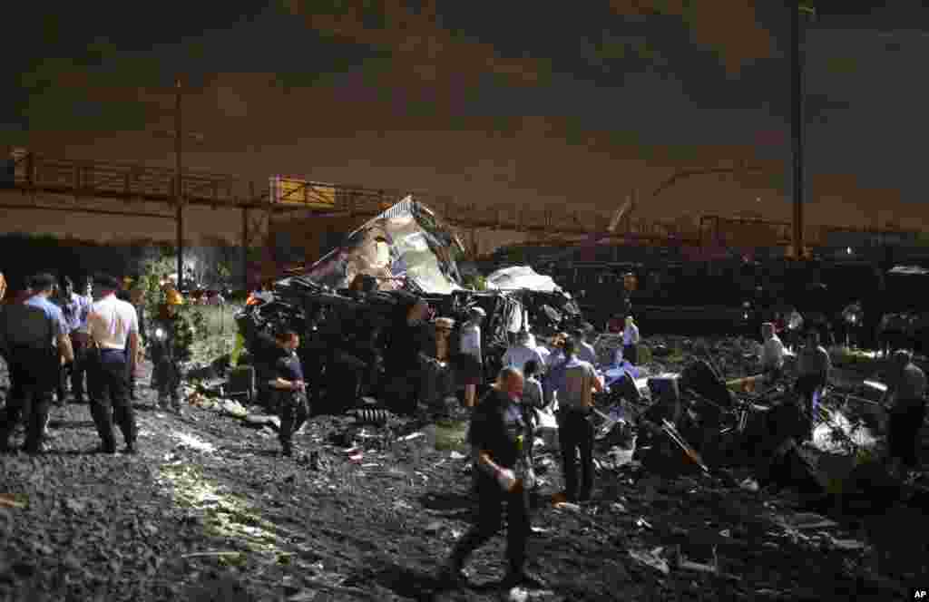 Petugas keadaan darurat bekerja di lokasi kecelakaan kereta di Philadelphia (12/5). (AP/Joseph Kaczmarek)