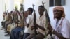 FILE- Armed men from the al-Shabab militant group are paraded at the presidential palace in Mogadishu, Somalia, after defecting from the al-Qaida-linked group to join government forces, Oct. 13, 2009.