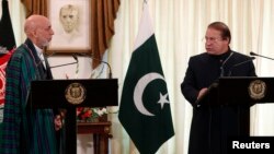 Pakistan's Prime Minister Nawaz Sharif (R) speaks during a joint news conference as Afghan President Hamid Karzai listens at the prime minister's residence in Islamabad, Aug. 26, 2013.