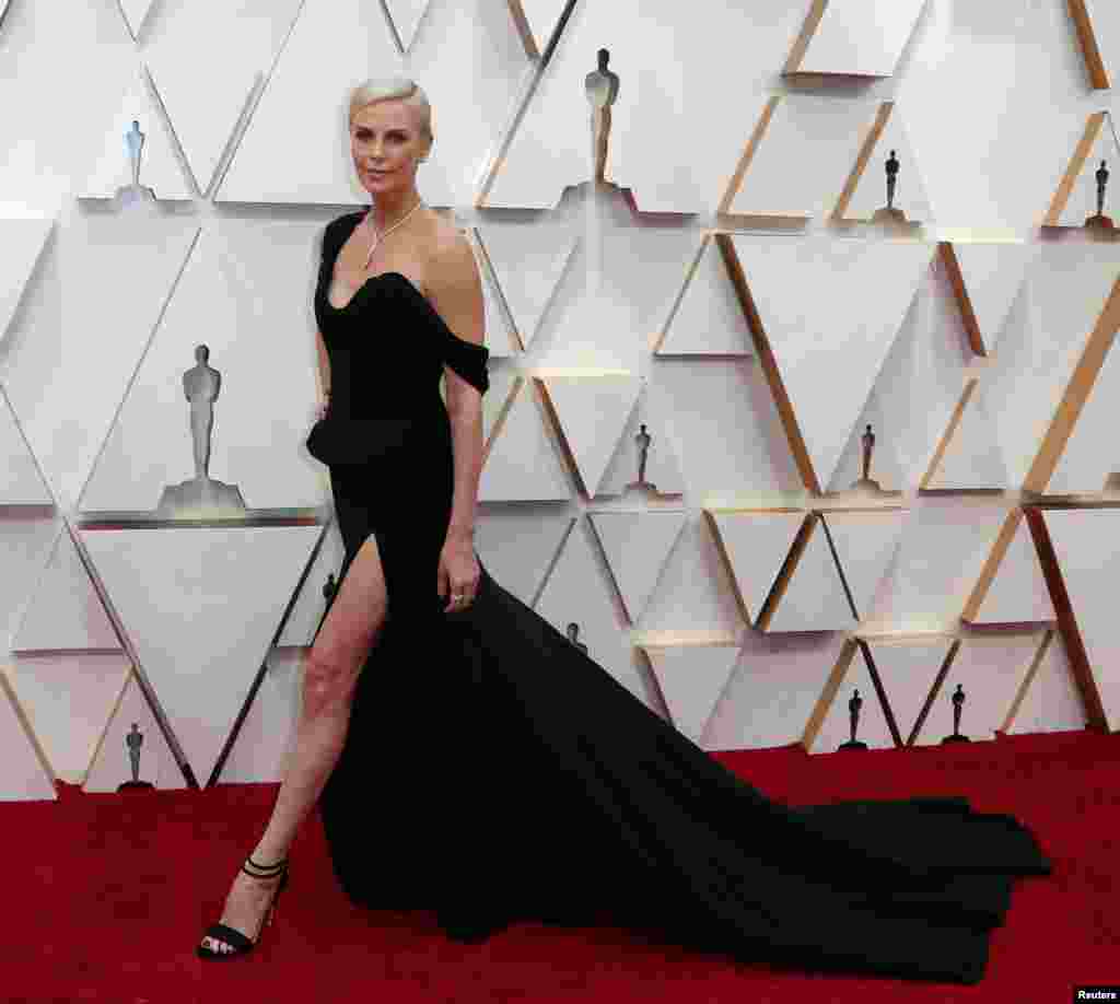 Charlize Theron in Dior and Tiffany & Co. jewelry poses on the red carpet during the Oscars arrivals at the 92nd Academy Awards in Hollywood, Feb. 9, 2020.