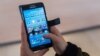 FILE - A woman uses an Android smartphone