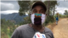 This Furcy resident, wearing a patchwork face mask, says locals make sunflower tea to soothe cold and flu-like symptoms. (Photo: Matiado vilme / VOA) 