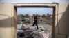 Palestinians inspect the ruins of a residential building for the Abu Muammar family after an Israeli airstrike in Rafah, Gaza Strip, on March 29, 2024.