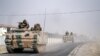 Turkish army tanks and armored personnel carriers move toward the Syrian border in Karkamis, Turkey, Aug. 25, 2016. 