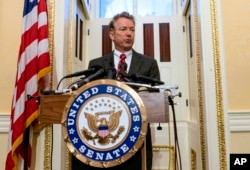 FILE - Sen. Rand Paul, R-Ky., answers reporters' questions during a news conference on Capitol Hill in Washington.