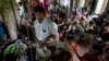 FILE - Internally displaced Rohingya people take shelter in a building ahead of the arrival of Cyclone Mahasen, in Sittwe, northwestern Rakhine State, Myanmar, May 15, 2013. 