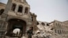 FILE - Shi'ite rebels, known as Houthis, stand guard in front of Yemen's Defense Ministry building in Sanaa, Yemen on June 10, 2015, after it was damaged by Saudi-led airstrikes. 