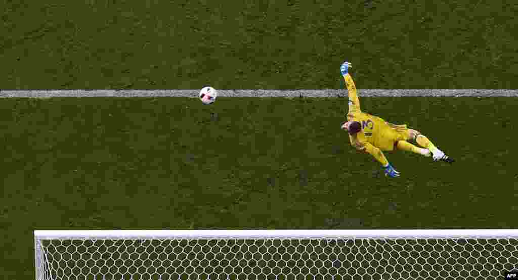 Spain's goalkeeper David De Gea jumps for the ball during the Euro 2016 round of 16 football match between Italy and Spain at the Stade de France stadium in Saint-Denis, near Paris, France.