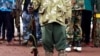 FILE - A former child soldier holds a gun as they participate in a child soldiers' release ceremony, outside Yambio, South Sudan, Aug. 7, 2018. 