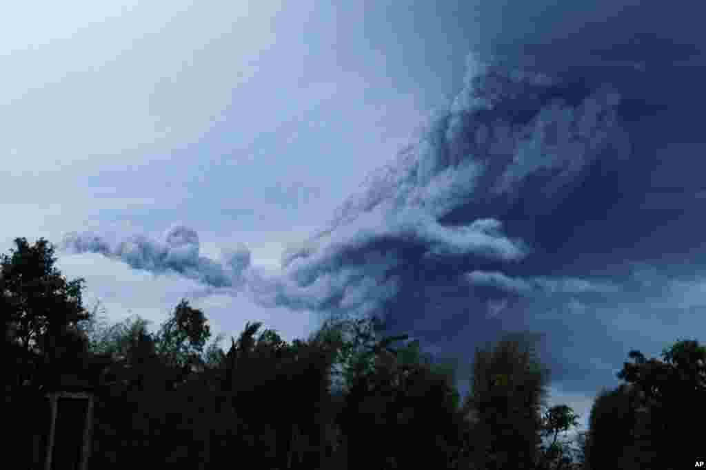 Mount Merapi spews volcanic material as it erupts as seen from Pakem near the ancient city of Yogyakarta, Indonesia, Nov. 18, 2013. 