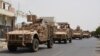 Yemeni fighters against Shiite rebels ride military vehicles on a street in the port city of Aden, July 14, 2015.