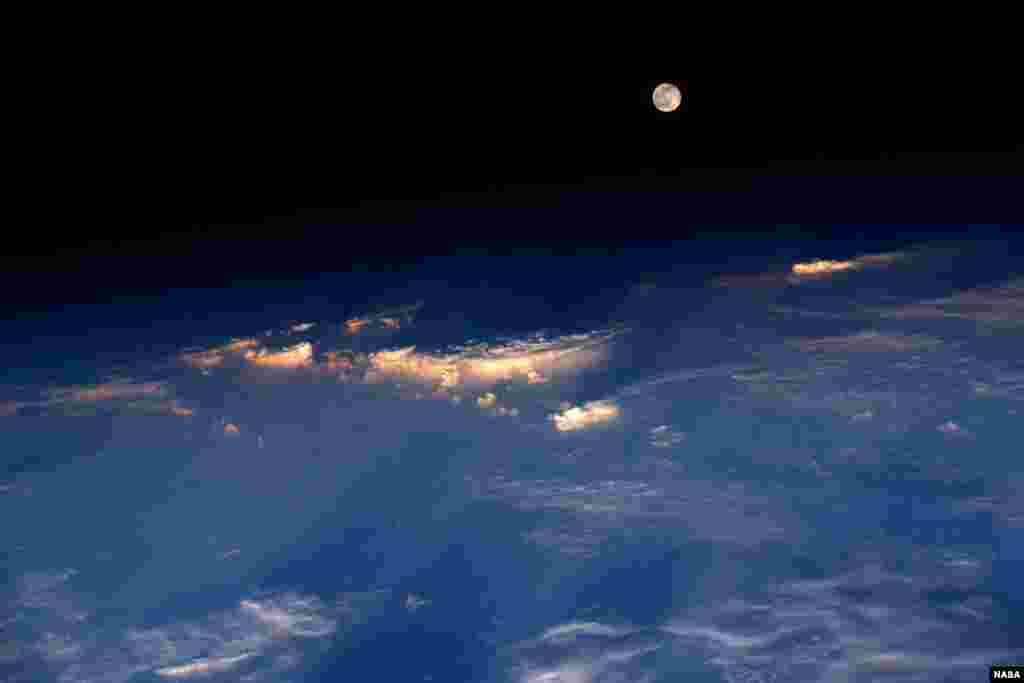 Expedition 48 Commander Jeff Williams of NASA took this photograph from the International Space Station. He wrote, "A spectacular rise of the full moon just before sunset while flying over western China."