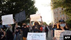 People march for the fourth day since the release of the grand jury report on the death of Breonna Taylor on Sept. 26, 2020, in Louisville, Kentucky.