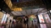 FILE - People shop at Taikoo Li Sanlitun in Beijing, China, July 2, 2024. 