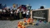 FILE - People stand with Orthodox crosses and icons as they attend a memorial service at the crash site of the Malaysia Airlines Flight 17, near the village of Hrabove, eastern Ukraine, July 17, 2015.