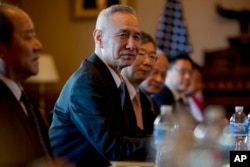 Chinese Vice Premier Liu He, center, accompanied by other Chinese officials, begins talks with U.S. Trade Representative Robert Lighthizer at the Executive Office Building on the White House Complex, Jan. 30, 2019.